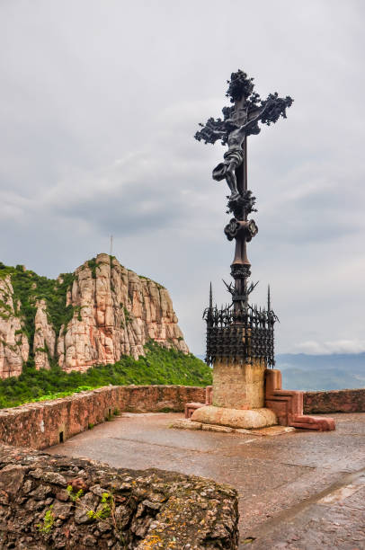 Statue of Jesus Christ crucified on a cross near Montserrat monastery in mountains near Barcelona, Spain Barcelona, Spain - July 2019: Statue of Jesus Christ crucified on a cross near Montserrat monastery in mountains near Barcelona what mountain was jesus crucified on stock pictures, royalty-free photos & images