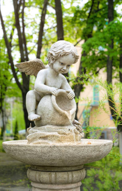 istock Cupid marble garden sculpture and decorative fountain 1317763477