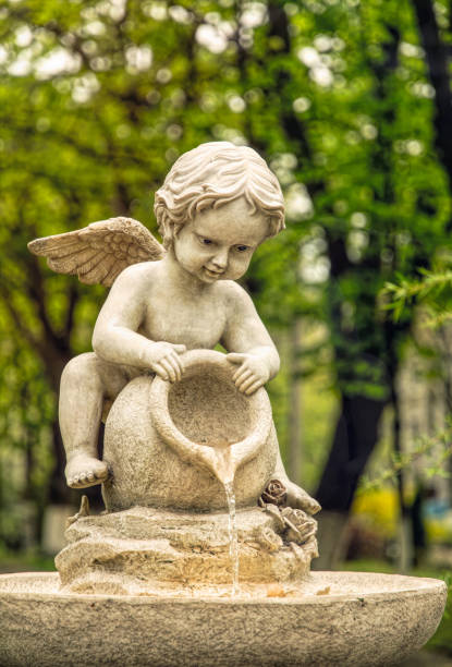 istock Cupid marble garden sculpture and decorative fountain 1317763479