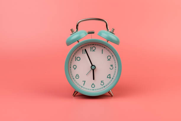 istock Old clock isolated on a pink background with space for text. Concept of time 1317763543