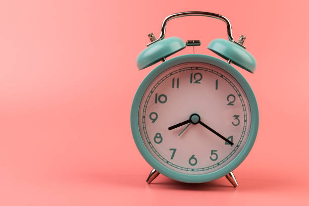 istock Old clock isolated on a pink background with space for text. Concept of time 1317763567