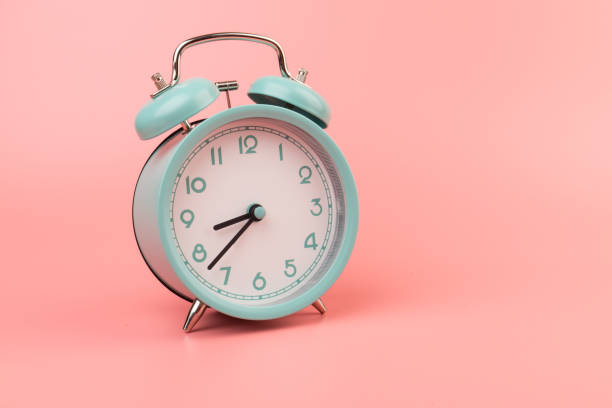 istock Old clock isolated on a pink background with space for text. Concept of time 1317763577