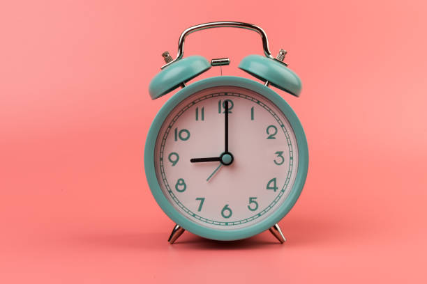 istock Old clock isolated on a pink background with space for text. Concept of time 1317763607