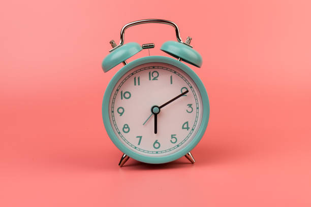 istock Old clock isolated on a pink background with space for text. Concept of time 1317763611