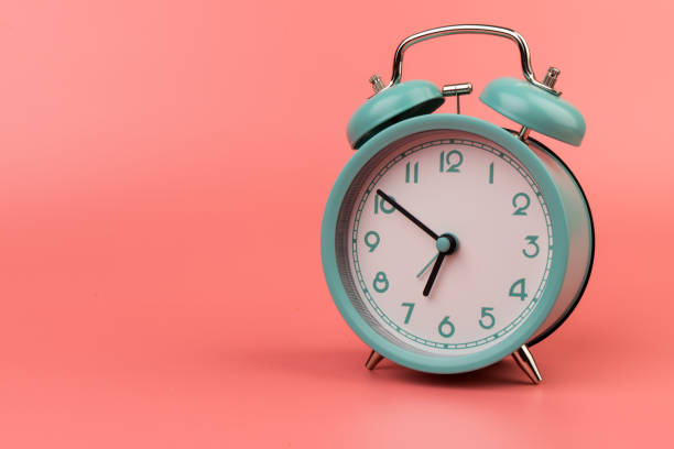 istock Old clock isolated on a pink background with space for text. Concept of time 1317763623