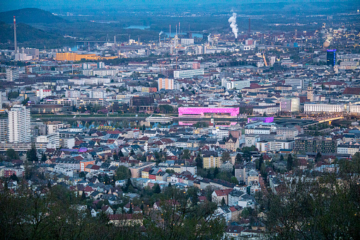 Linz an der Donau, is the capital of Upper Austria.  Overview from the Pöstlingberg to the City. The Lentos, museum of modern art is in the center, the industrial area of the VÖEST is situated in the background.