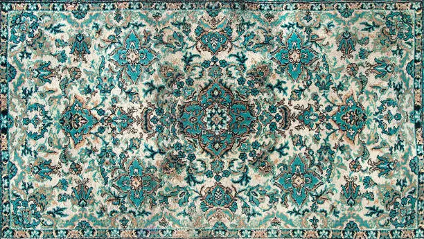 Photo of The texture of a Persian carpet, an abstract ornament. Round Mandala Pattern, Traditional Middle Eastern Carpet Fabric Texture. Turquoise milky green beige, light green, brown. vintage,oriental motifs