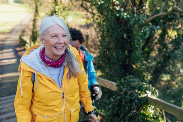 sorridere in primavera - hiking senior adult exercising outdoors foto e immagini stock