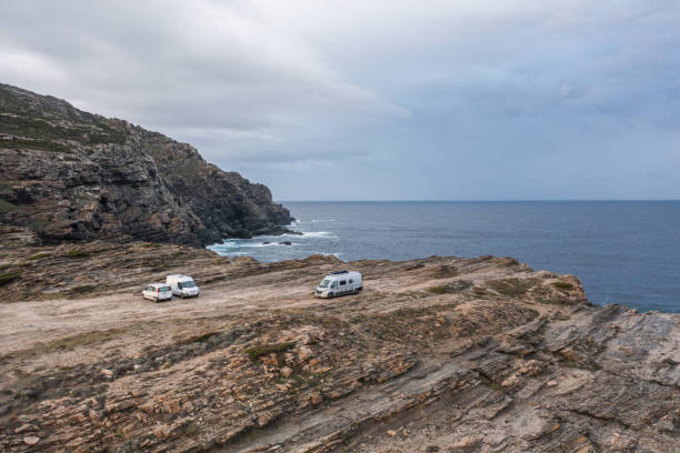 istock Drone view of coastline, vans parked on cliff 1317768025