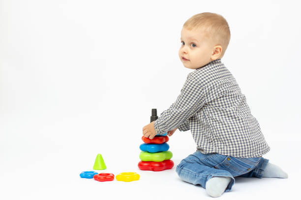 istock Boy playing with plastic toys white background isolated. 1317768815