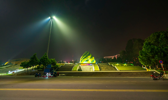 Da Lat, Vietnam - April 2nd, 2021: Night view at Lam Vien Square with a lot of mist surrounded by mysterious street lights, exciting destination for travel in Da Lat, Vietnam