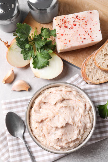 istock Delicious lard spread in bowl on table, flat lay 1317770759