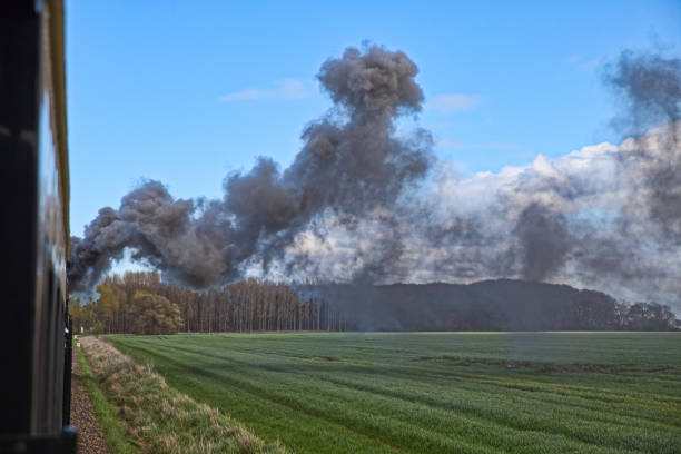 istock steam train on a field with black smoke 1317770876
