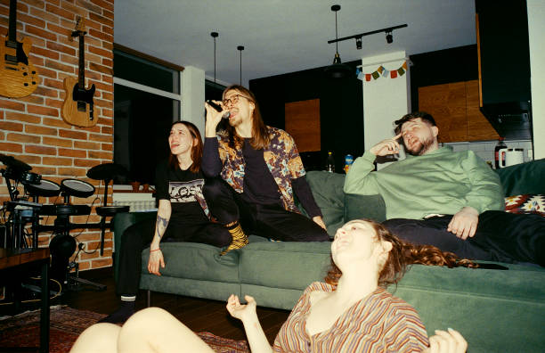 Friends having fun at home. Singing karaoke Friends having fun at home. Singing karaoke. Camera film with flash party funny stock pictures, royalty-free photos & images