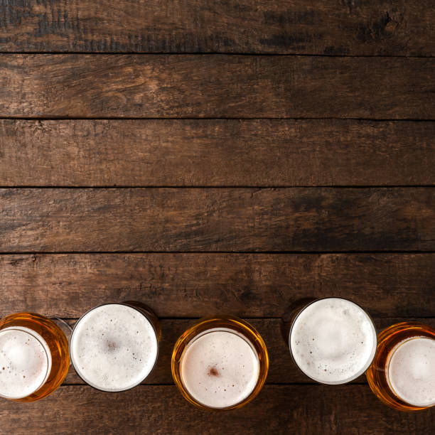 istock Beer glasses on wooden table with copyspace. 1317774430