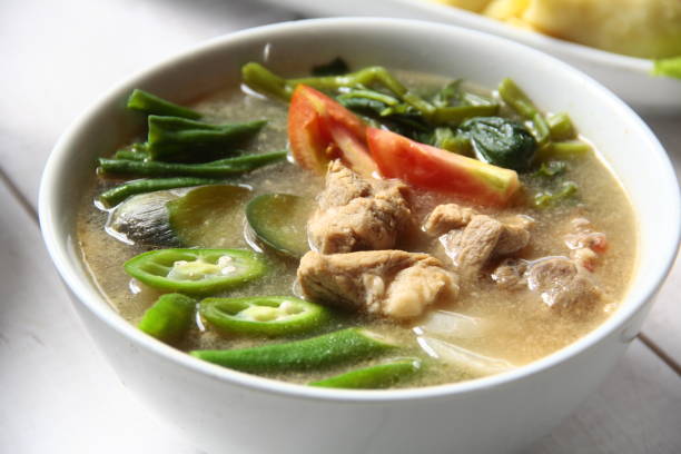 Filipino food called Pork Sinigang or pork and vegetables in tamarind broth stock photo