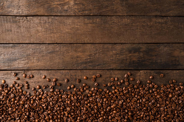 istock Coffee beans on wooden background with copyspace. 1317775225
