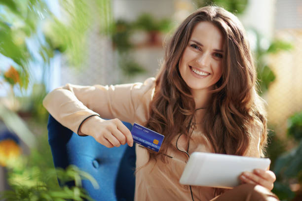 istock smiling elegant female in sunny day using tablet PC 1317775597