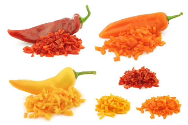 Red, orange and yellow sweet pepper (capsicum) and cut pieces  on a white background