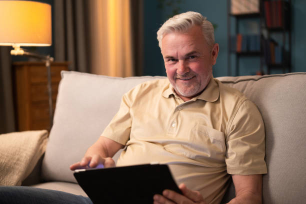 istock Elderly man sitting with tablet contentedly using electronic device. Retired man getting to know, learning to use tablet. Happy elderly man learning how the internet works 1317779220