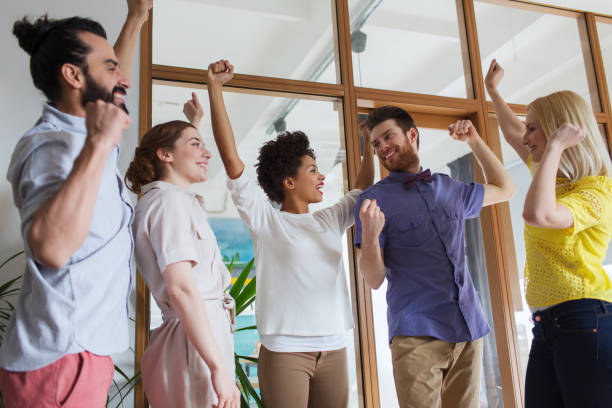 istock happy creative team celebrating victory in office 1317780053