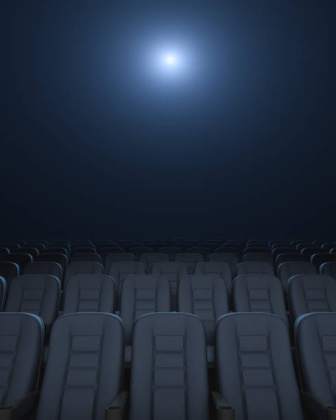 istock Empty auditorium. Rows of armchairs. Glowing Cinema Projector. 1317780592