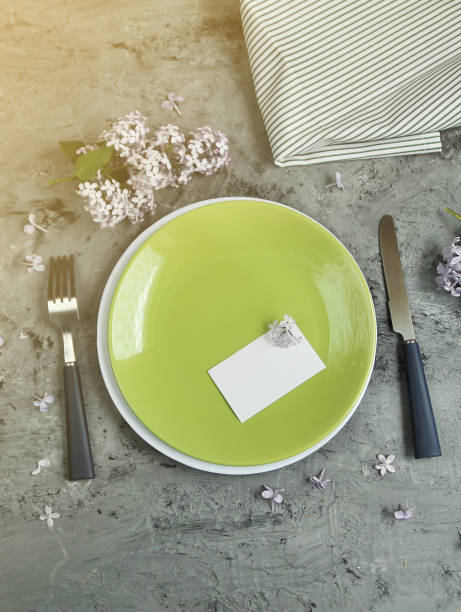 istock Decorated table. Plate with cutlery and lilac flowers 1317781240