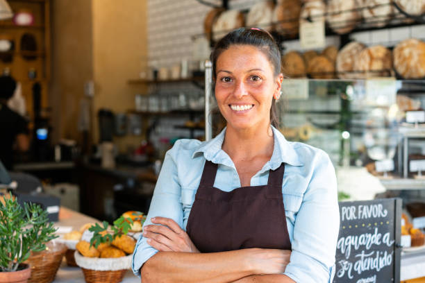 istock Confident female barista smiling in bakery 1317781644