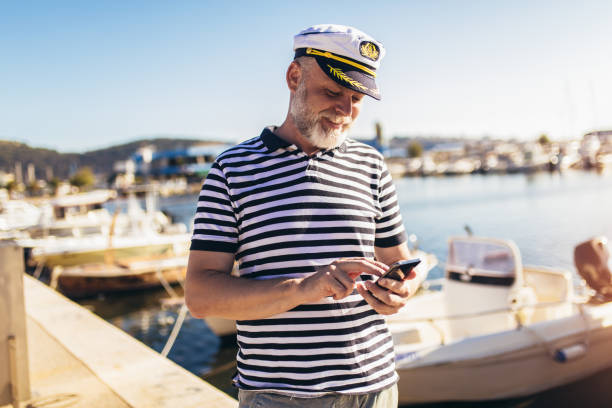 istock Man standing near the sea using smart phone 1317781829