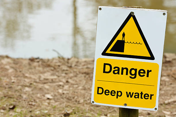 istock Deep water warning sign next to water. 131778351