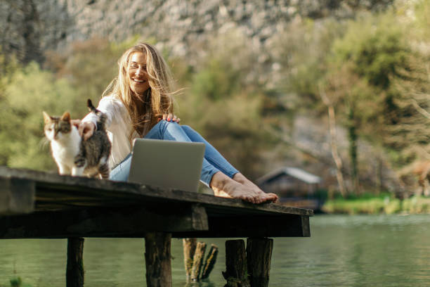istock Young woman using laptop in nature 1317783742