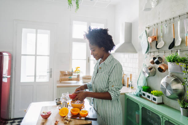 istock Young woman preparing oatmeal with pomegranate for breakfast 1317783781