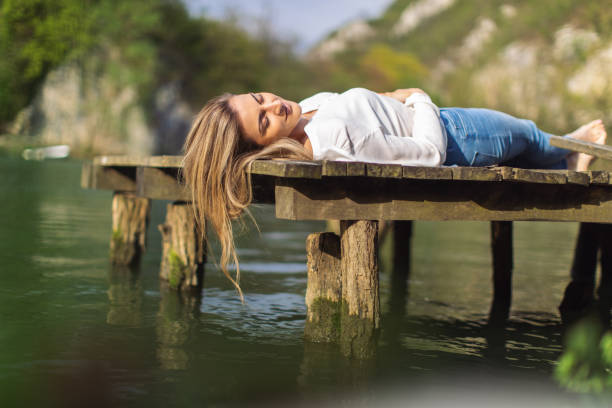 istock Beautiful woman enjoying next to the river 1317783944