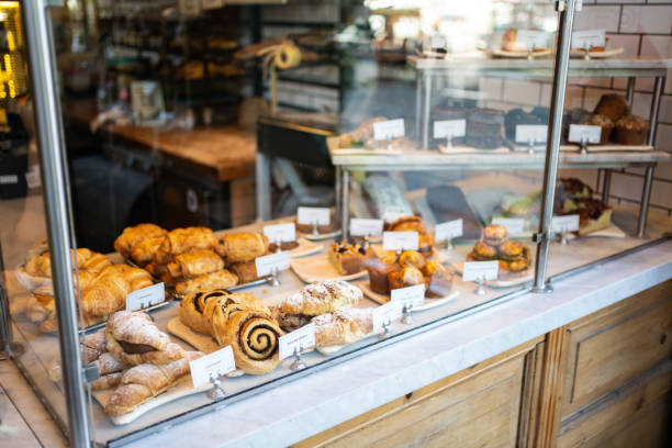 Various baked food in glass cabinet at bakery