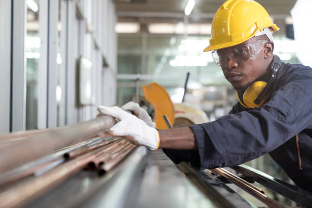 istock Tube tool. Worker is holding in hands a brass pipe trimming. Engineer is holding in hands a pipe tool. 1317784144