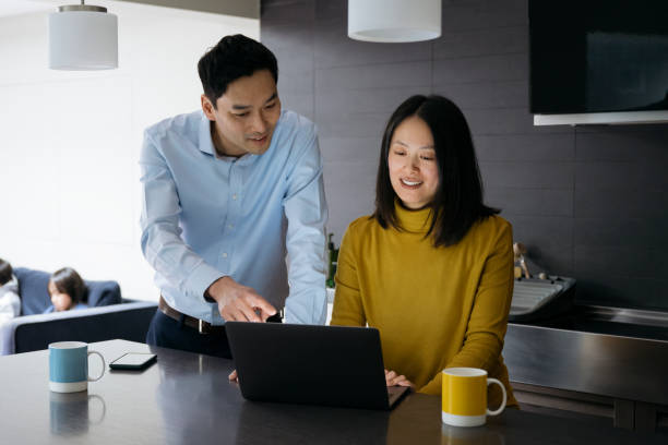 istock Mature Chinese couple enjoying coffee while using laptop 1317784212