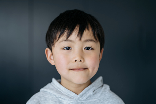 Young boy posing to the camera showing his face and expressions in Latin America.