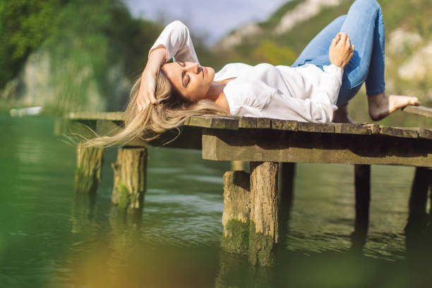 istock Beautiful woman enjoying next to the river 1317784326