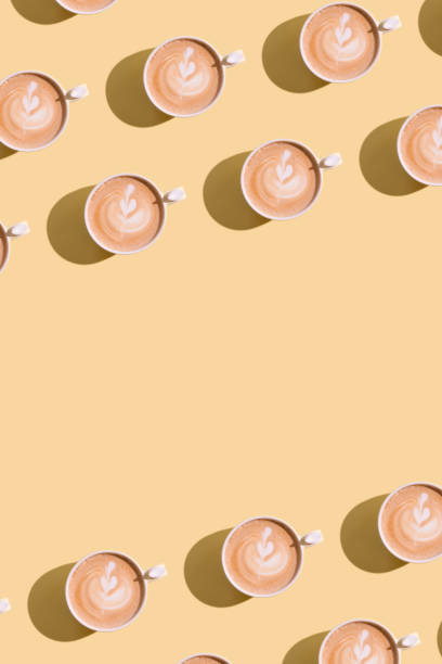 istock Pattern cappuccino and heart decoration on foam with hard shadow on colored background with copy space 1317784363