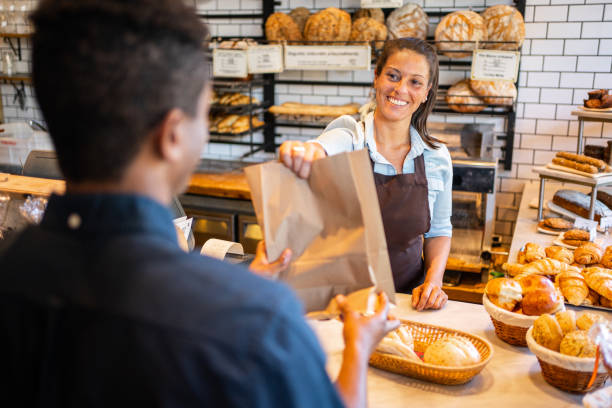 istock Bakery staff giving food parcel to customer 1317785335