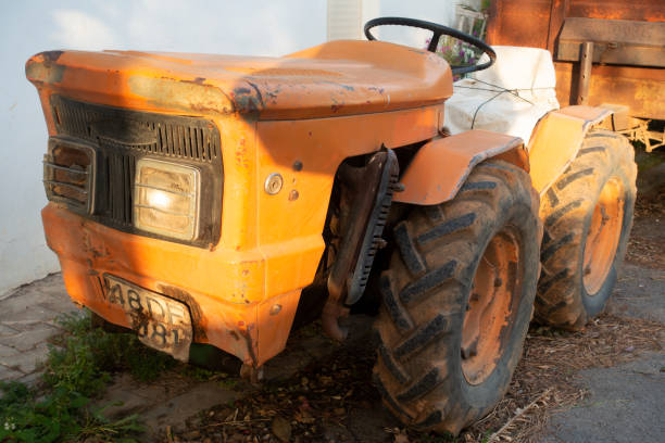 istock Orange tractor is parked nerear the stone house. 1317786481