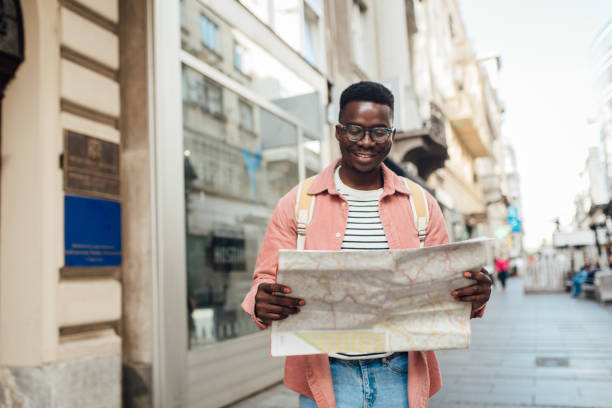 istock Happy African American sightseeing the city using the map 1317787075