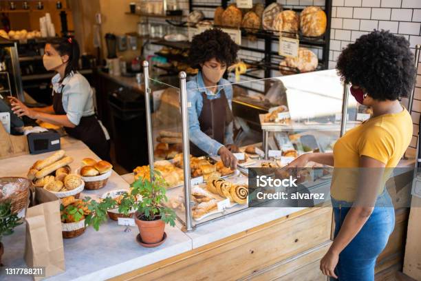 Woman Customer Choosing Baked Products To Buy At A Bakery Stock Photo - Download Image Now