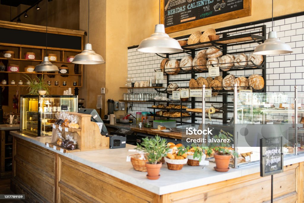 Interior of a local coffee shop Interior of a local coffee shop. Bakery counter with freshly baked food displayed for selling. Bakery Stock Photo