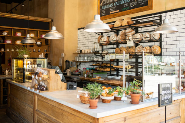 Interior of a local coffee shop Interior of a local coffee shop. Bakery counter with freshly baked food displayed for selling. coffee shop stock pictures, royalty-free photos & images