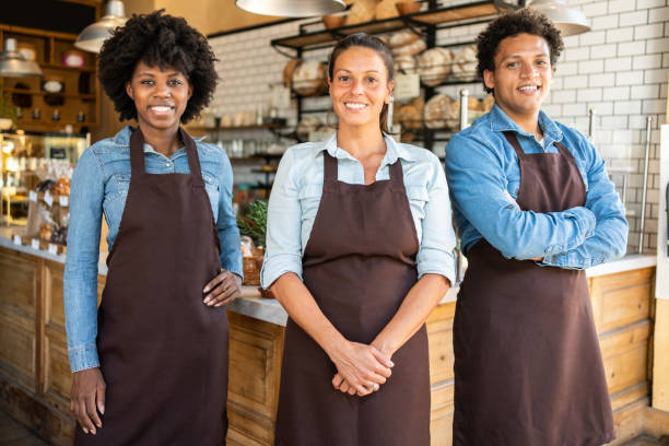istock Group of a coffee shop staff wearing aprons 1317789518