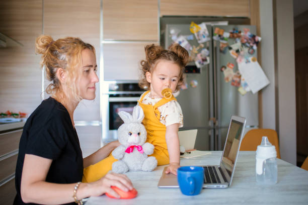 istock Mother playing game with her baby between online meeting. 1317790328