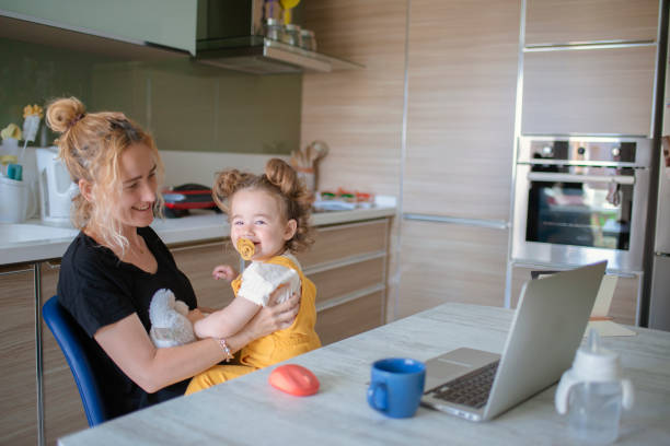 istock Mother playing game with her baby between online meeting. 1317790563