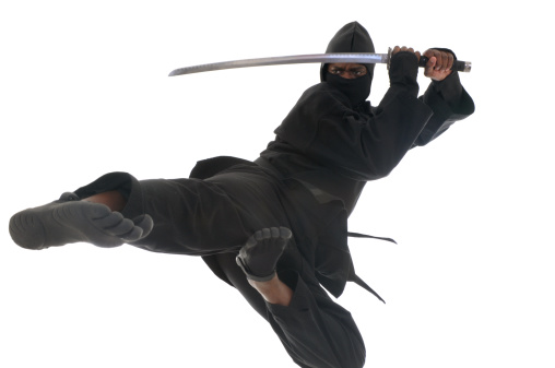 Ninja leaping in the air with a sword.