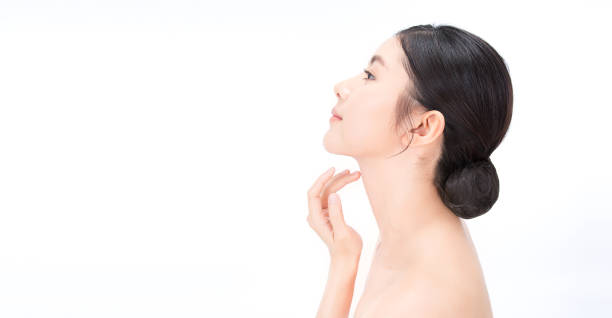 Closeup portrait of beauty asian woman with fair perfect healthy lift glow skin hand touching chin isolated on white, beautiful asia girl with pretty smile on face. Beauty korean spa skincare banner Closeup portrait of beauty asian woman with fair perfect healthy lift glow skin hand touching chin isolated on white, beautiful asia girl with pretty smile on face. Beauty korean spa skincare banner neck stock pictures, royalty-free photos & images